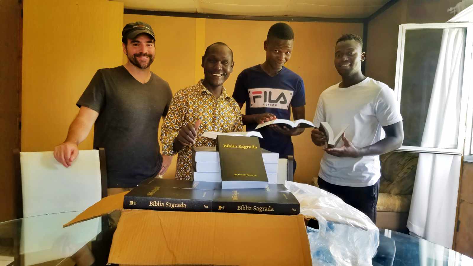Jason, Abel, Roc, and Tony opening a delivery of new Bibles in Mozambique
