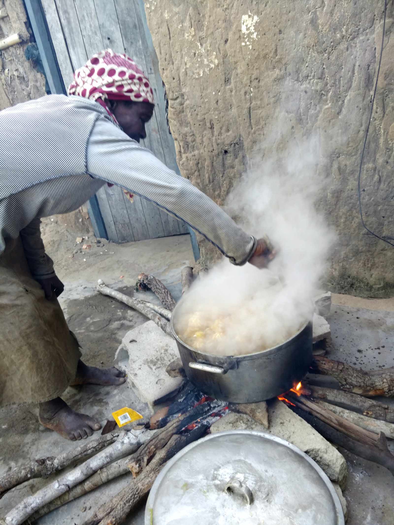 The day starts early for the children's ministry team who begin preparing the children's hot lunch over an open fire.