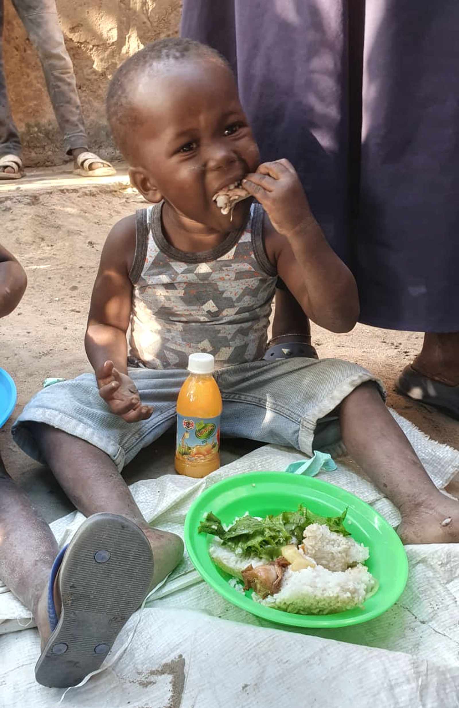 A child eating a meal provided through Hope of a Nation