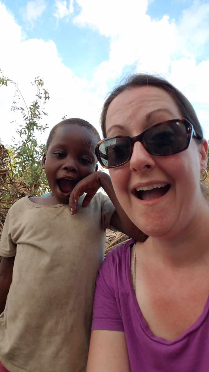 Executive Co-Director Susan Collmorgen with a child in Mozambique
