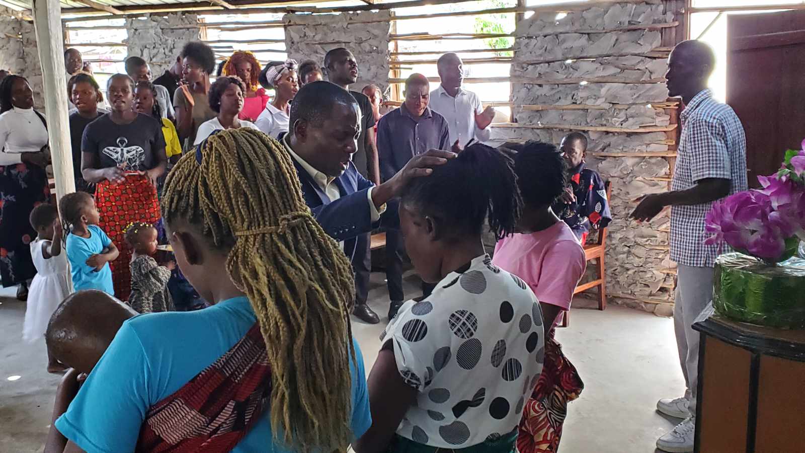 Pastor Pascoal praying over a woman in one of our partner churches in Mozambique.