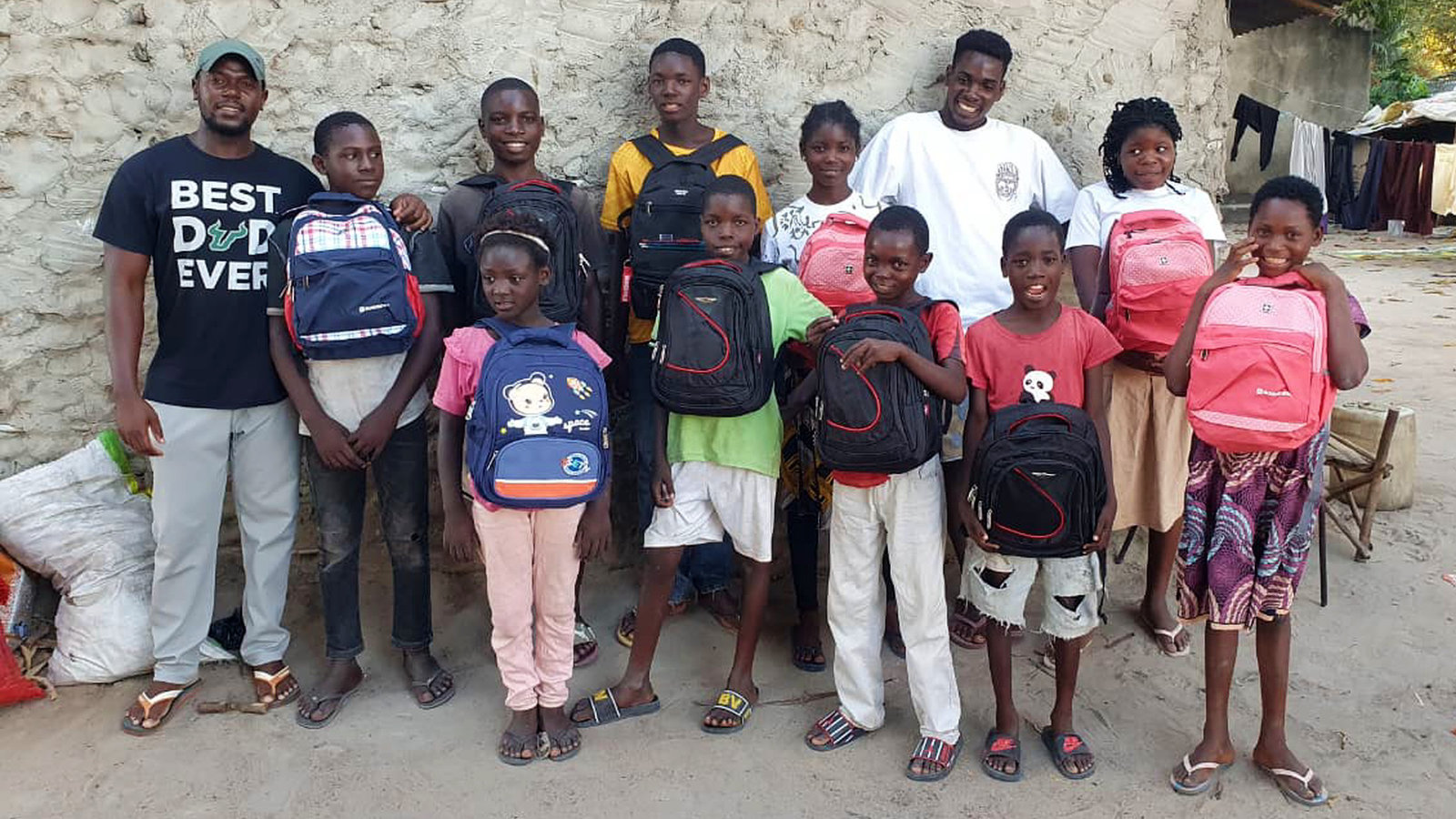 Some of our younger children in Mozambique with new school backpacks, alongside Children's Services Director Tony and one of the ministry's older boys